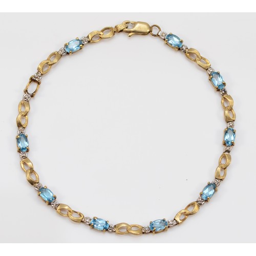 64 - A 9ct gold oval cut blue topaz bracelet, 17cm, 3.6g