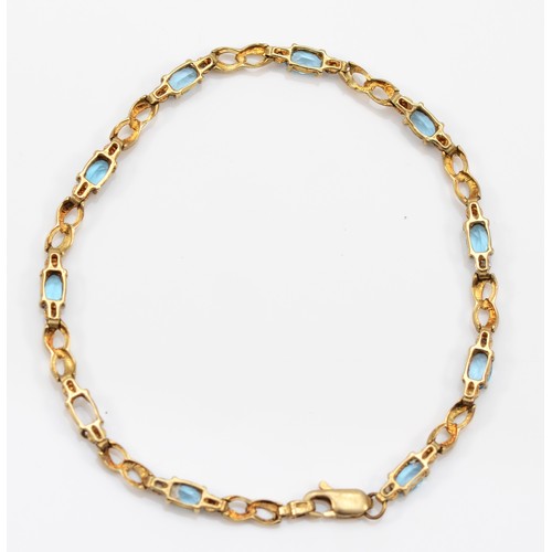 64 - A 9ct gold oval cut blue topaz bracelet, 17cm, 3.6g