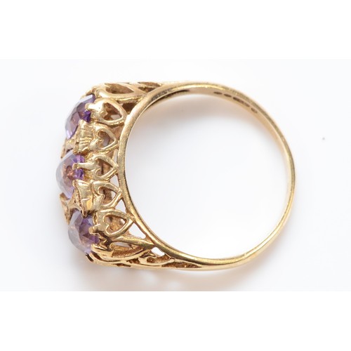 66 - A 9ct gold antique oval cut amethyst three stone ring with a heart patterned gallery, O 1/2, 3.6g