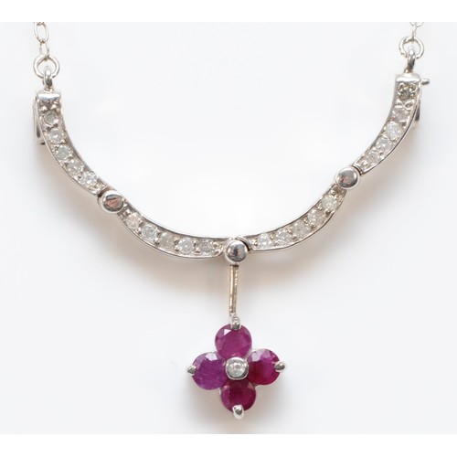 185 - A 14K white gold ruby and diamond pendant, pendant opens and closes, 20mm closed, 3.8g