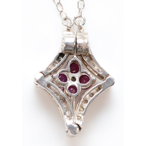 185 - A 14K white gold ruby and diamond pendant, pendant opens and closes, 20mm closed, 3.8g