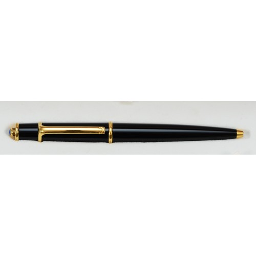 180 - A Diabolo de Cartier ballpoint pen, black with gilt fittings, with instruction book and guarantee da... 