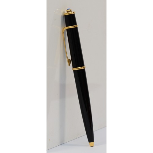 180 - A Diabolo de Cartier ballpoint pen, black with gilt fittings, with instruction book and guarantee da... 