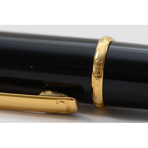 180 - A Diabolo de Cartier ballpoint pen, black with gilt fittings, with instruction book and guarantee da... 