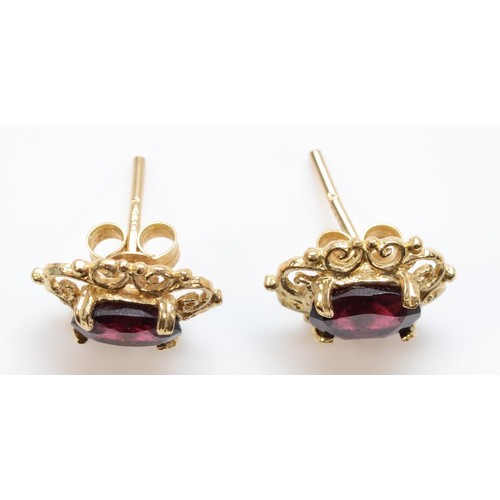 235 - A 9ct gold pair of garnet ear studs, 1.7gm