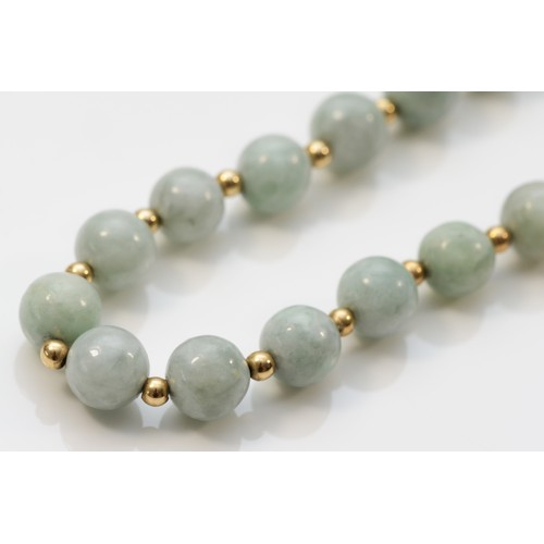 255 - A 7mm jadeite bead necklace with 14K beads between, 46cm