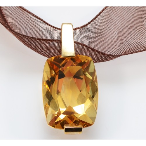 262 - A 9ct gold mounted citrine pendant, of good cut and colour, mounted on a gold mounted fabric ribbon,... 