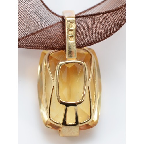 262 - A 9ct gold mounted citrine pendant, of good cut and colour, mounted on a gold mounted fabric ribbon,... 