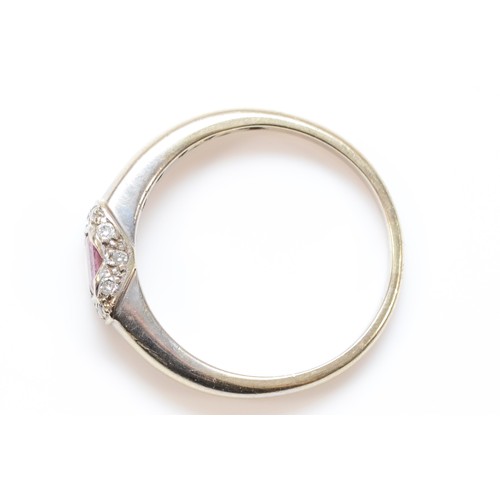 282 - A 9ct white gold pink sapphire and brilliant cut diamond ring, P 1/2, 2.7gm