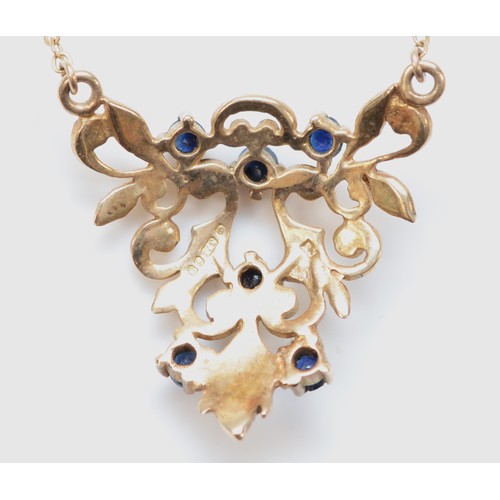 304 - A 9ct gold and sapphire openwork pendant, 23 x 23mm, chain, 3gm