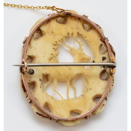 317 - A continental gold mounted carved bone brooch, depicting a stag, 44 x 35mm, 9.6gm