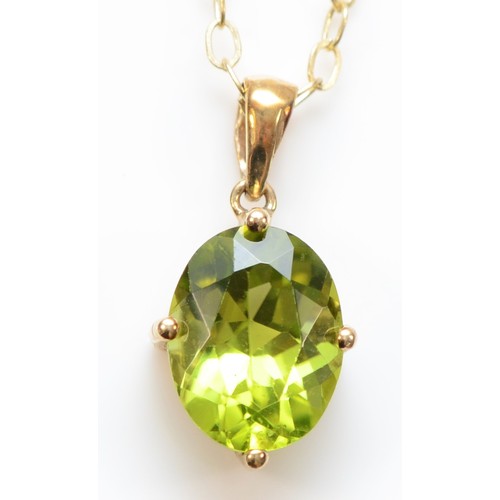 342 - A 9ct gold oval peridot single stone pendant with necklace, 10mm pendant, 1.7g