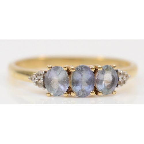 350 - A 10K gold tanzanite and white gemstone trefoil ring, R 1/2, 2.2g