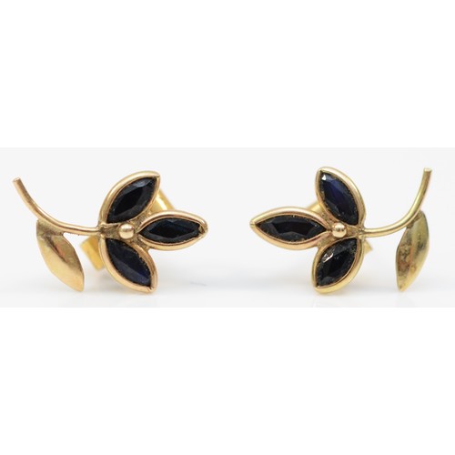 364 - A pair of 9ct gold marquise cut sapphire floral stud earrings, with scroll backs, bezel set, 0.6g