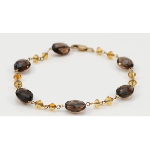 6 - A 9ct gold faceted smokey quartz and citrine bracelet, 17.5cm, 5g