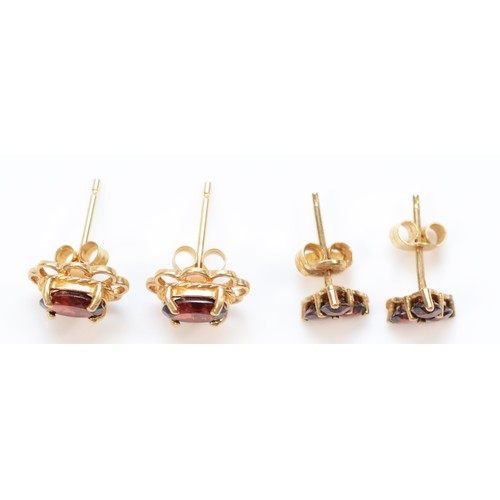 41 - Two pairs of 9ct gold garnet stud earrings with scroll backs, 1.6g