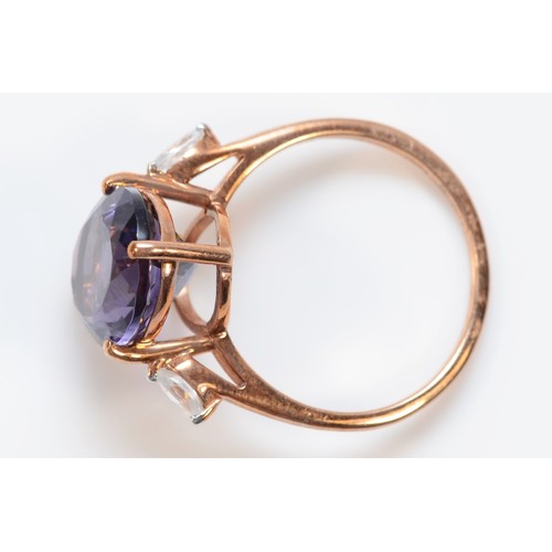 60 - A 9ct rose gold amethyst and white gemstone dress ring, O, 2.8g