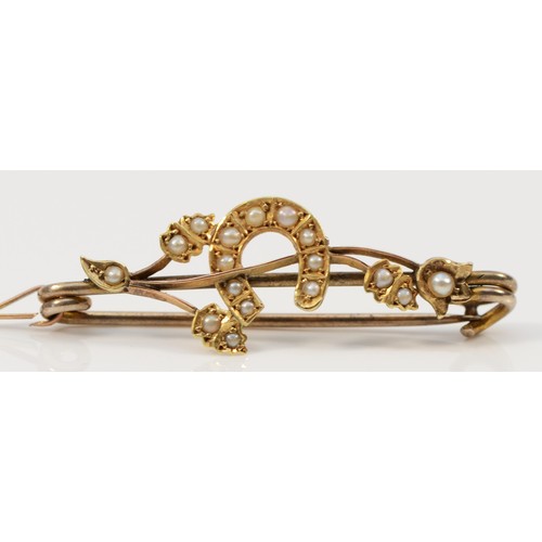 68 - A 15ct gold antique seed pearl floral horseshoe brooch with a low carat pin, 40mm across, 2.7g