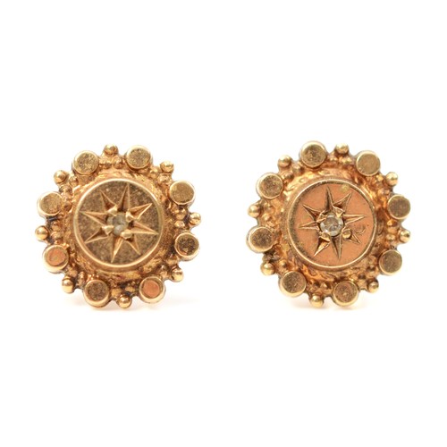 73 - A pair of 9ct gold star set diamond stud earrings with scroll backs, 1.7g