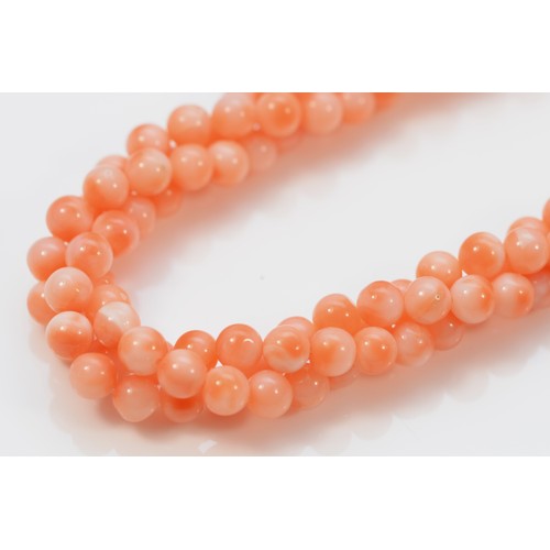 82 - A 9ct gold coral necklace, 34.6g