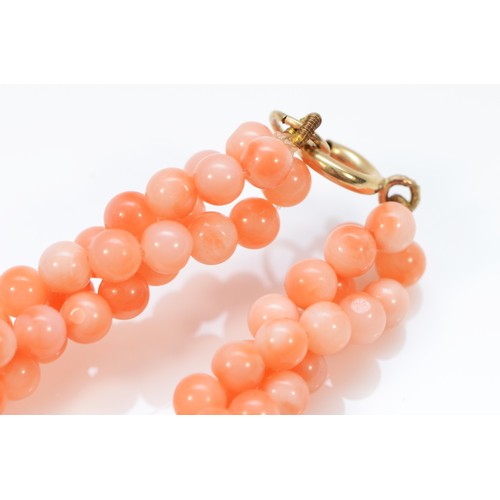 82 - A 9ct gold coral necklace, 34.6g