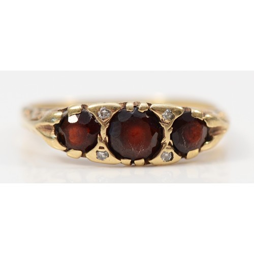 125 - A 9ct gold vintage garnet and diamond ring with patterned gallery, O, 2.6g