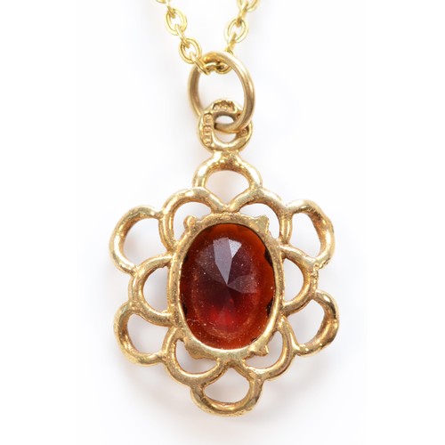 131 - A 9ct gold oval cut garnet pendant with necklace, 15mm diameter, 2.3g