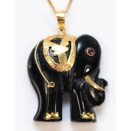 318 - A 9ct gold black onyx and ruby elephant pendant with necklace, 25mm elephant, 7.2g