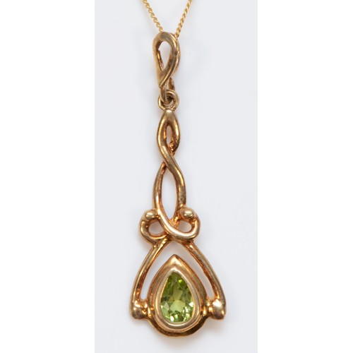 323 - A 9ct gold pear cut peridot Celtic style pendant with necklace, 35mm pendant, 1.8g