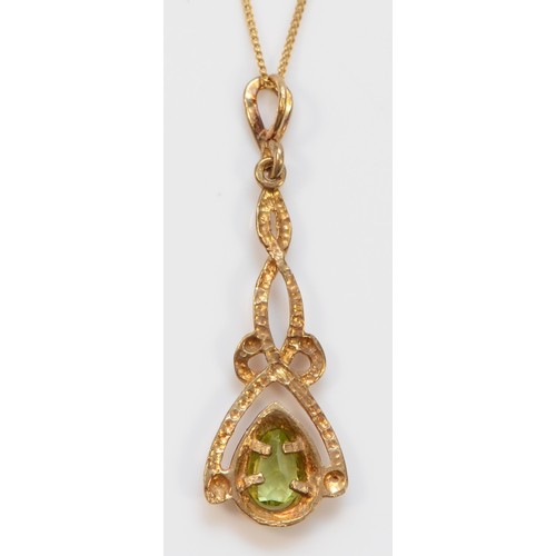 323 - A 9ct gold pear cut peridot Celtic style pendant with necklace, 35mm pendant, 1.8g