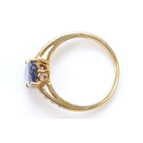 330 - A 9ct gold oval cut blue gemstone dress ring with diamond shoulders, L, 2g