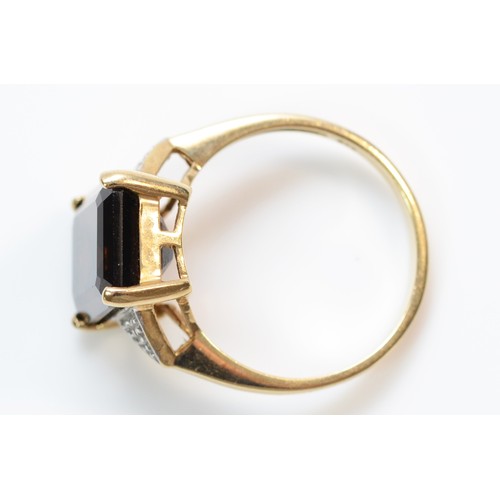 365 - A 9ct gold diamond accented smokey quartz set cocktail ring, R, 3.8g