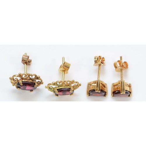 374 - Two pairs of 9ct gold garnet stud earrings with scroll backs, 2.9g