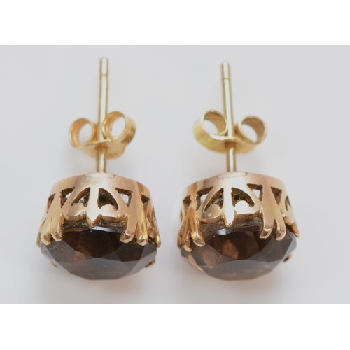 384 - A pair of 9ct gold smokey quartz solitaire stud earrings, 10mm diameter, 3.6g