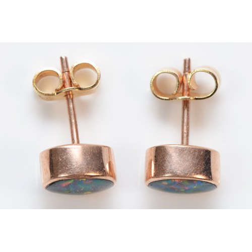 396 - A pair of 9ct rose gold synthetic black opal triplet cabochon stud earrings, 1.7g