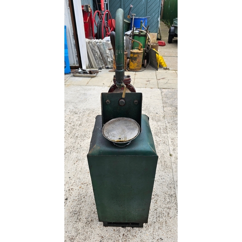 105 - A green forecourt oil dispenser