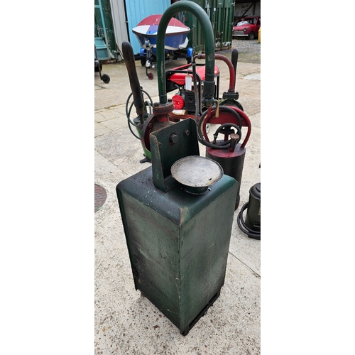 105 - A green forecourt oil dispenser