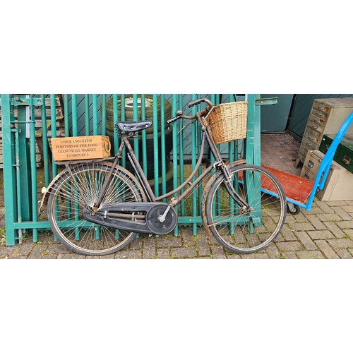 322 - A vintage ladies bicycle, frame number D52827, with basket and rod brakes