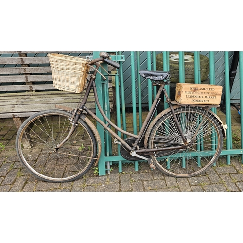 322 - A vintage ladies bicycle, frame number D52827, with basket and rod brakes