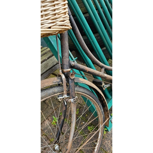 322 - A vintage ladies bicycle, frame number D52827, with basket and rod brakes