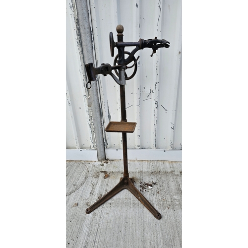 324 - A Millennium cast iron two bicycle stand with tool tray