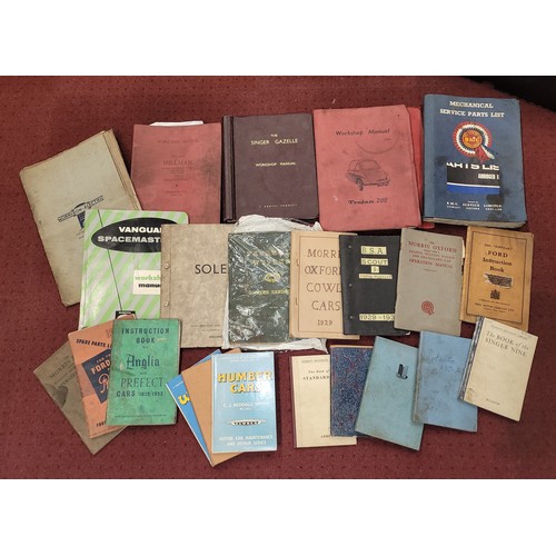 26 - A large collection of mid 20th century motor car related maintenance books, owners manuals, workshop... 