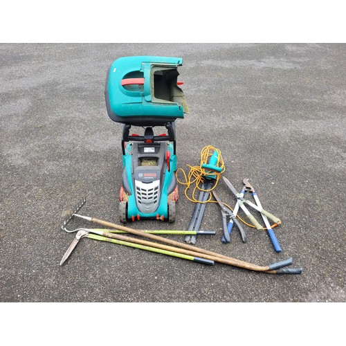 23 - Electrical hand tools to include Bosch Rotak lawnmower, Bosch hedge trimmer also, a qty of garden ha... 