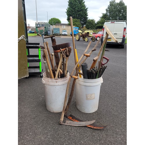 50 - 2 x large white tubs to contain a qty of garden hand tools to include spades, folks, brushes and rak... 