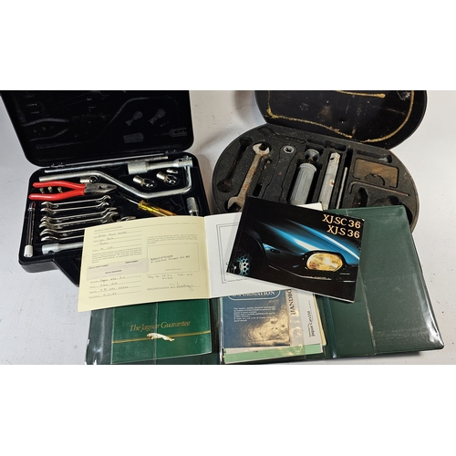 67 - A 1986 Jaguar XJS toolkit, service books and a Daimler/Jaguar MkII incomplete metal toolkit