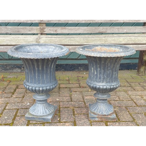 A pair of painted cast metal campana garden urns, 47cm tall. (2)