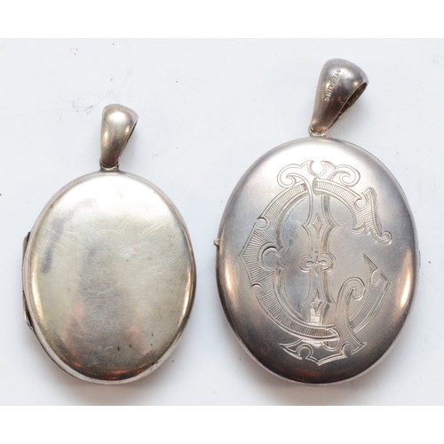 6 - A Victorian unmarked silver oval locket, 45 x 38mm and another smaller example, 27gm