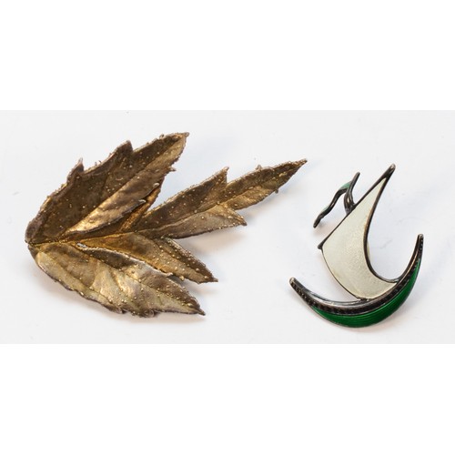 32 - Ivor Holth, a Norwegian silver and enamel Viking longboat brooch,32mm and a Flora Danika silver gilt... 