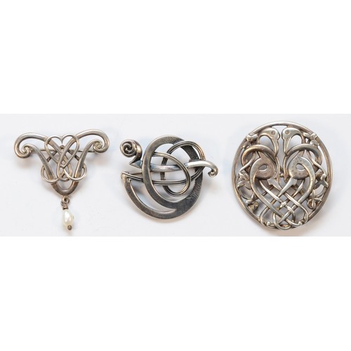 33 - Ola Gorie, a silver entwined sea serpent brooch, 35mm and two other Ola Gorie silver brooches, 25gm