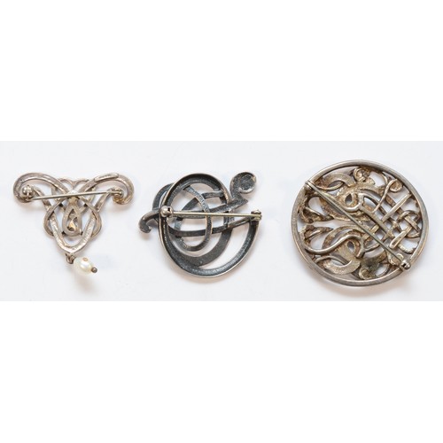 33 - Ola Gorie, a silver entwined sea serpent brooch, 35mm and two other Ola Gorie silver brooches, 25gm